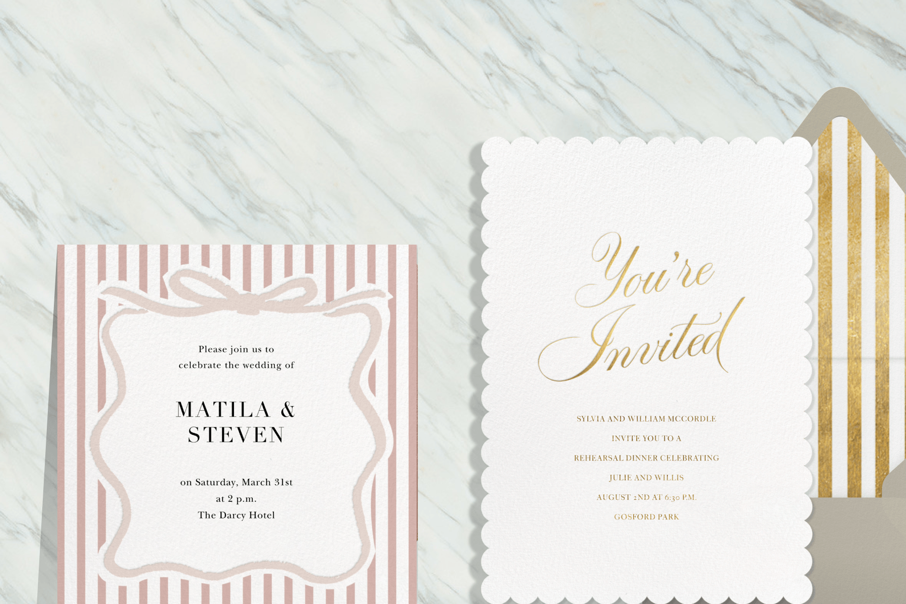A white and pink striped wedding invitation and a white rehearsal dinner invitation with gold cursive lettering sit on a white marble backdrop. Next to the rehearsal dinner invitation is a tan envelope with white and gold striped lining.