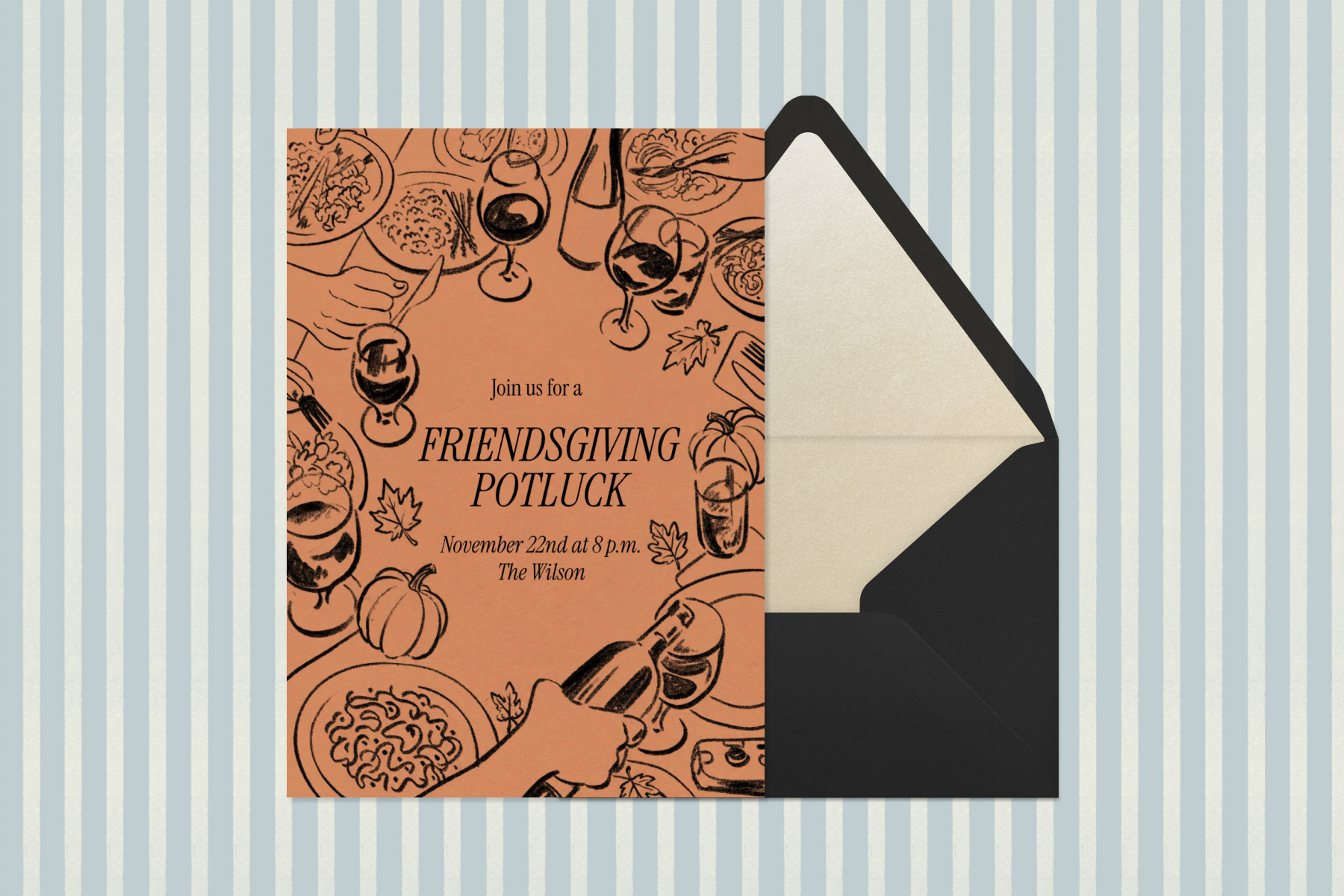 An orange Friendsgiving potluck invitation with black illustrations of a feast on a table sits beside a black envelope with a champagne liner against a light blue and white striped backdrop.
