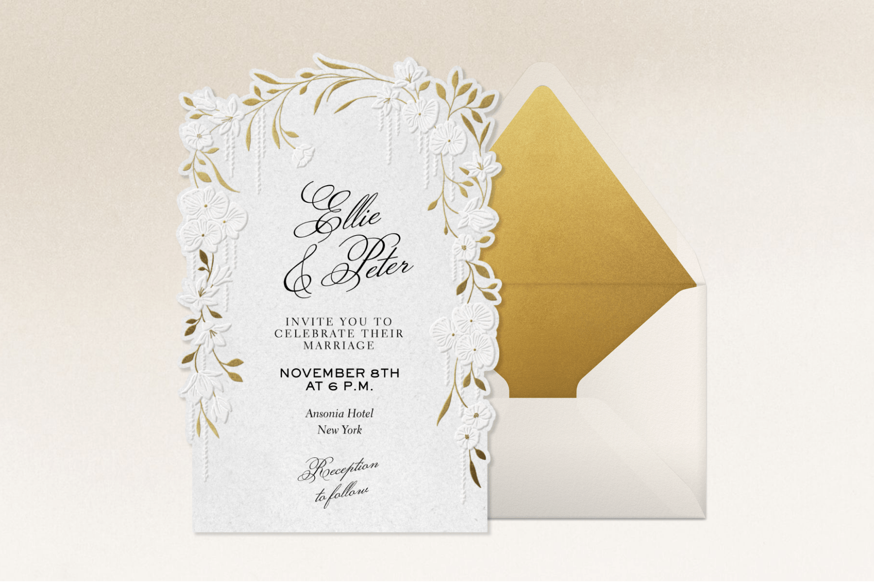 On a white gradient backdrop, a white wedding invitation with a gold floral border sits next to a white envelope with gold lining. The invitation reads ‘Ellie & Peter’ in black script above smaller event details.