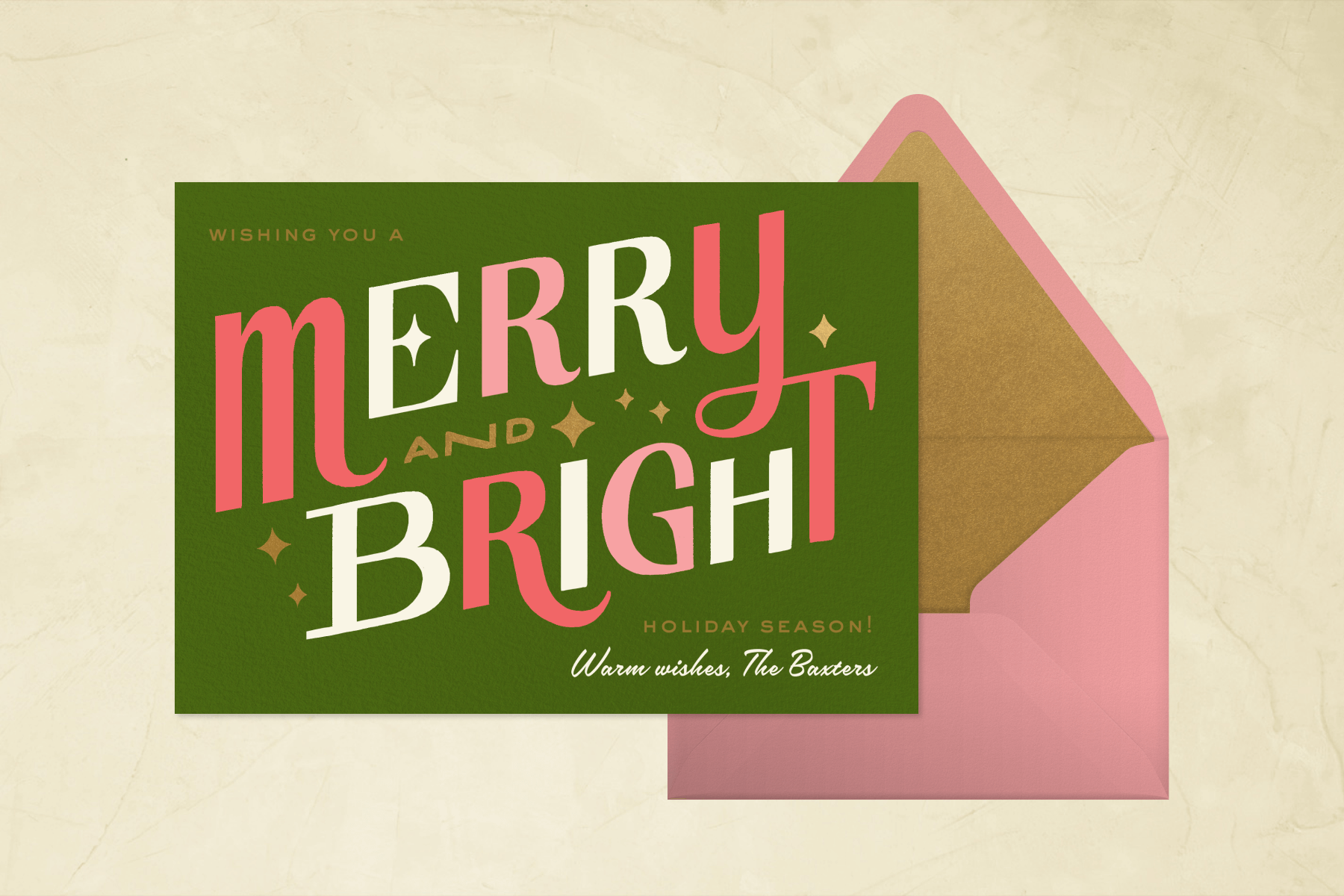 A green holiday card (with a pink envelope) reads “MERRY AND BRIGHT” in large pink, gold, and white letters.