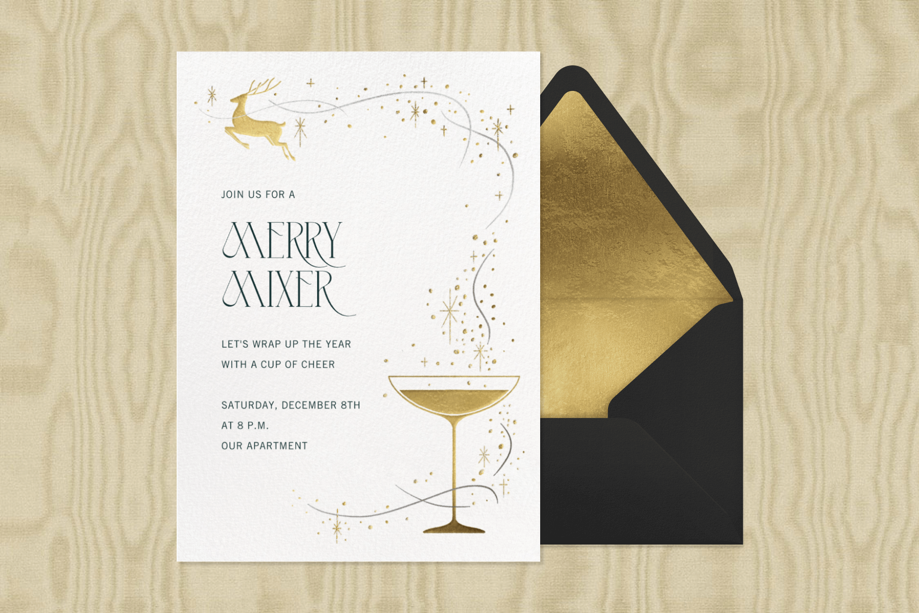 An invitation for a “merry mixer” has a delicate gold illustration of a small deer flying away from a coupe glass leaving stardust in its wake.