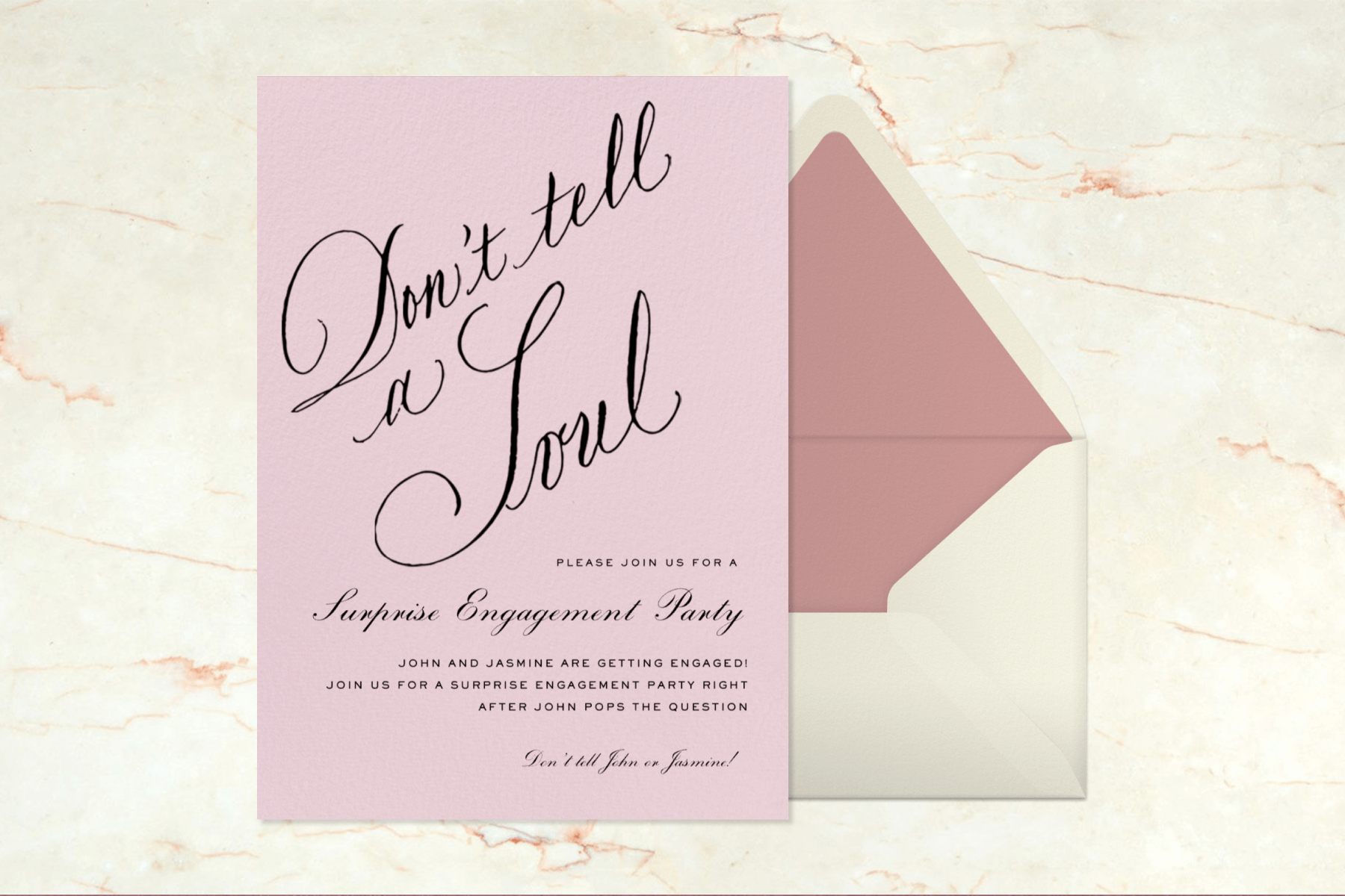 A blush engagement party invitation with large calligraphic text that reads “Don’t tell a Soul” paired with a cream and pink envelope.