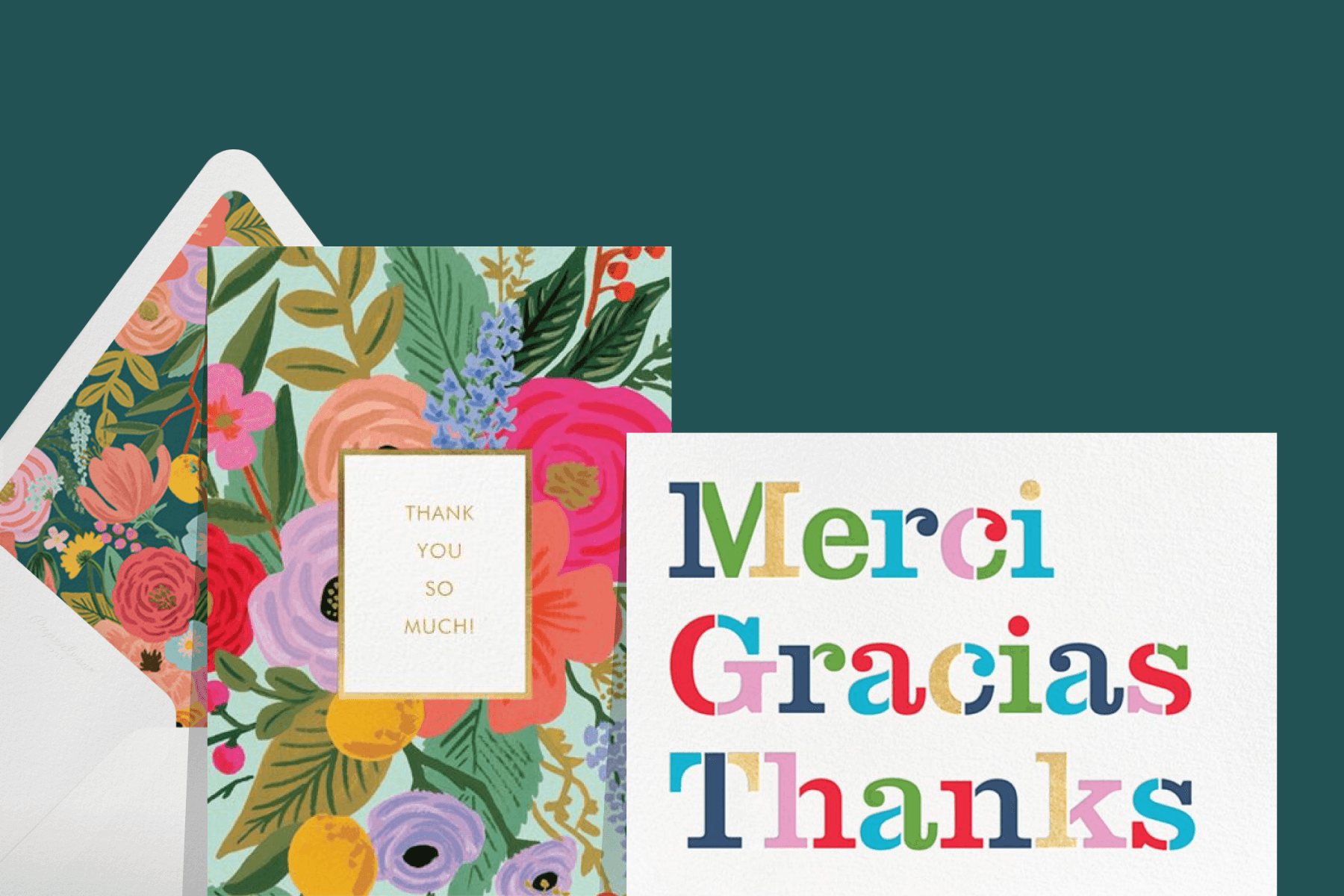 Two thank you cards. The one on the left has bright illustrations of mixed flowers with a matching envelope. The one on the right says “Merci, Gracias, Thanks” in rainbow text.