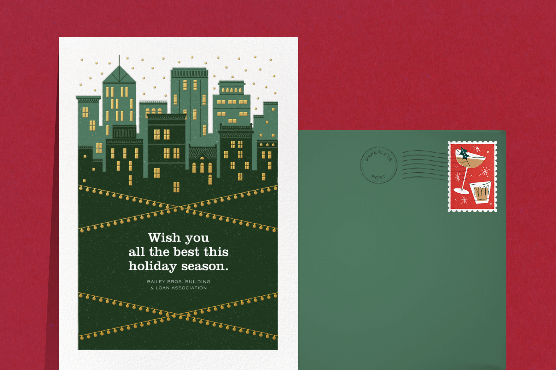 A holiday card with a green skyline of city buildings with string lights criss-crossed in front.