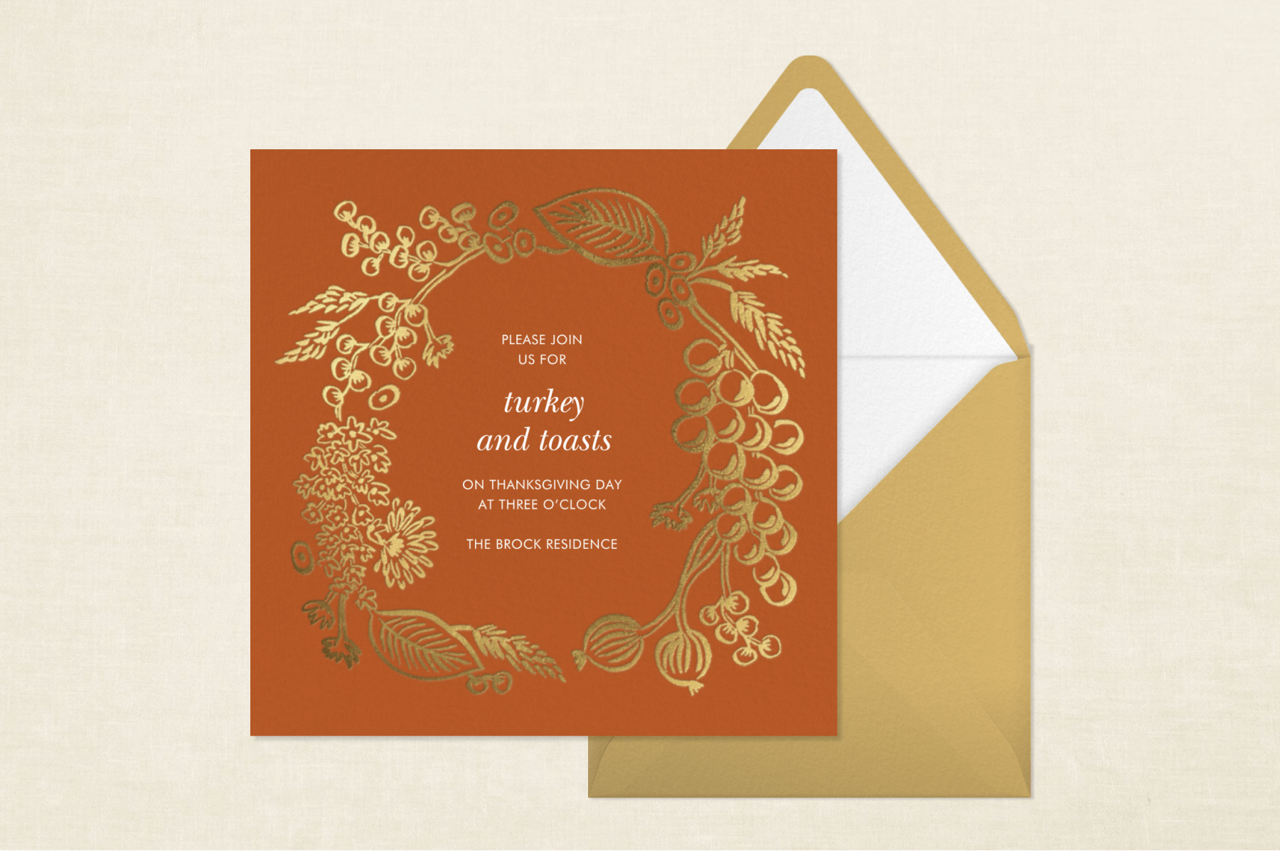 A russet-colored invitation for “turkey and toasts” with a gold berry border and gold envelope.