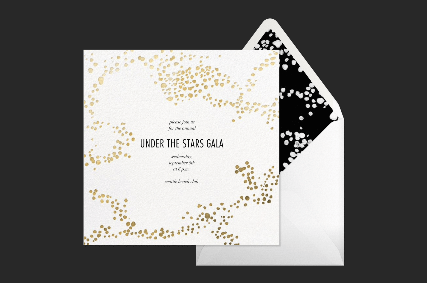 An “under the stars gala” invitation with gold speckles in an abstract pattern beside a white envelope with black and white liner.