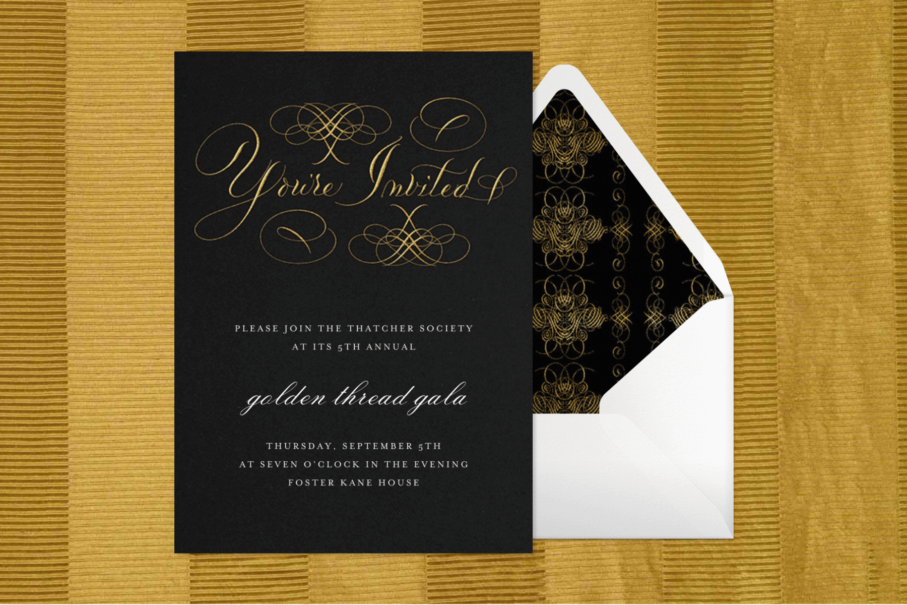 A black “Golden Threat Gala” invitation with ornate gold calligraphy spelling “You’re Invited” at the top beside an envelope with matching liner.