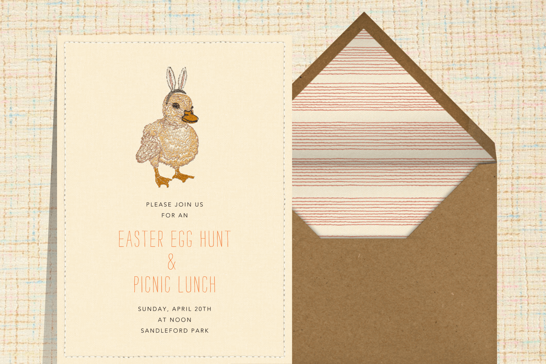 An invitation featuring an embroidered duckling wearing bunny ears.