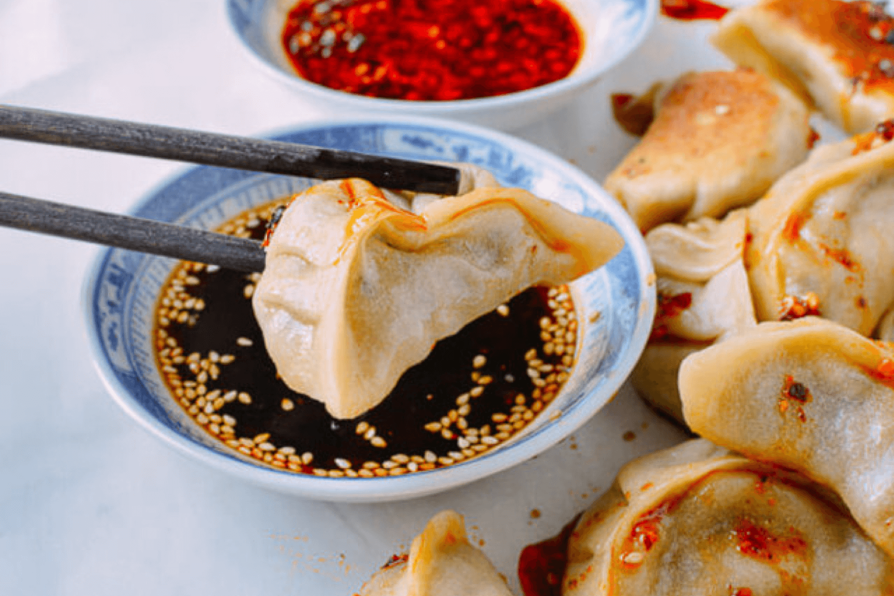 A close up of a dumpling and dipping sauce.