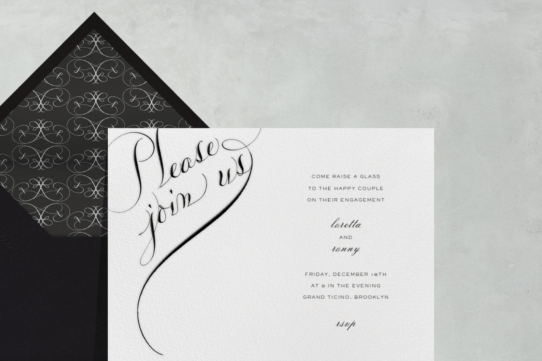 A white and black wedding invitation with calligraphy.