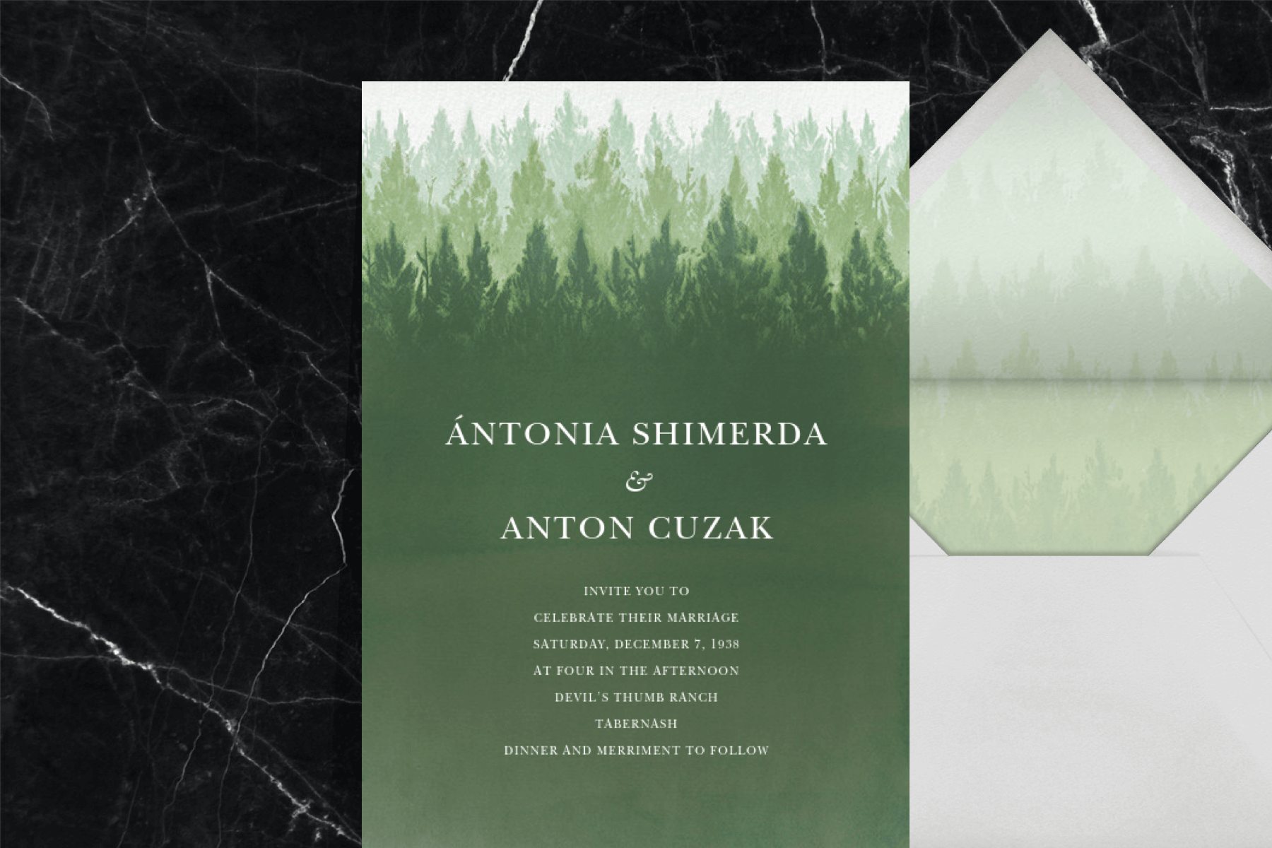 A green wedding invitation with an evergreen forest motif.