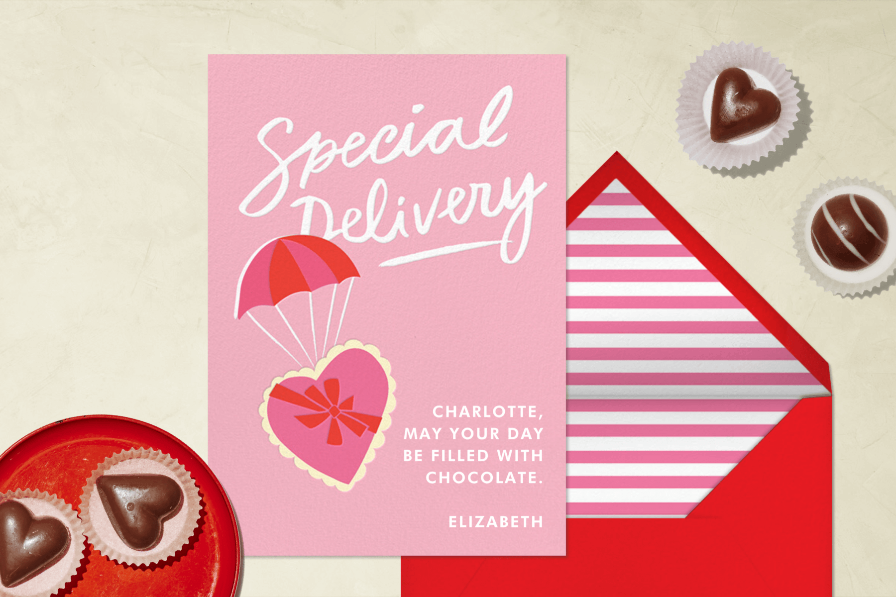 A Valentine’s Day card with a candy box wearing a parachute.