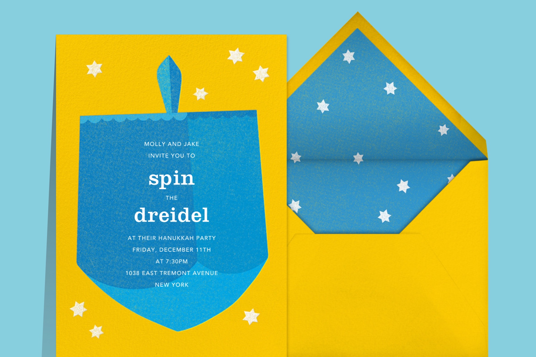 ALT: A yellow Hanukkah invitation with a blue dreidel and matching envelope. 
