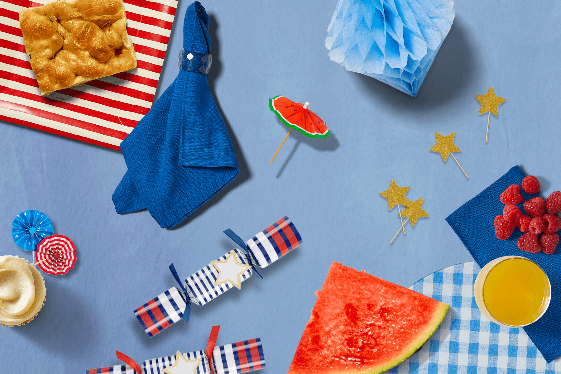 4th of July party supplies on a blue background.