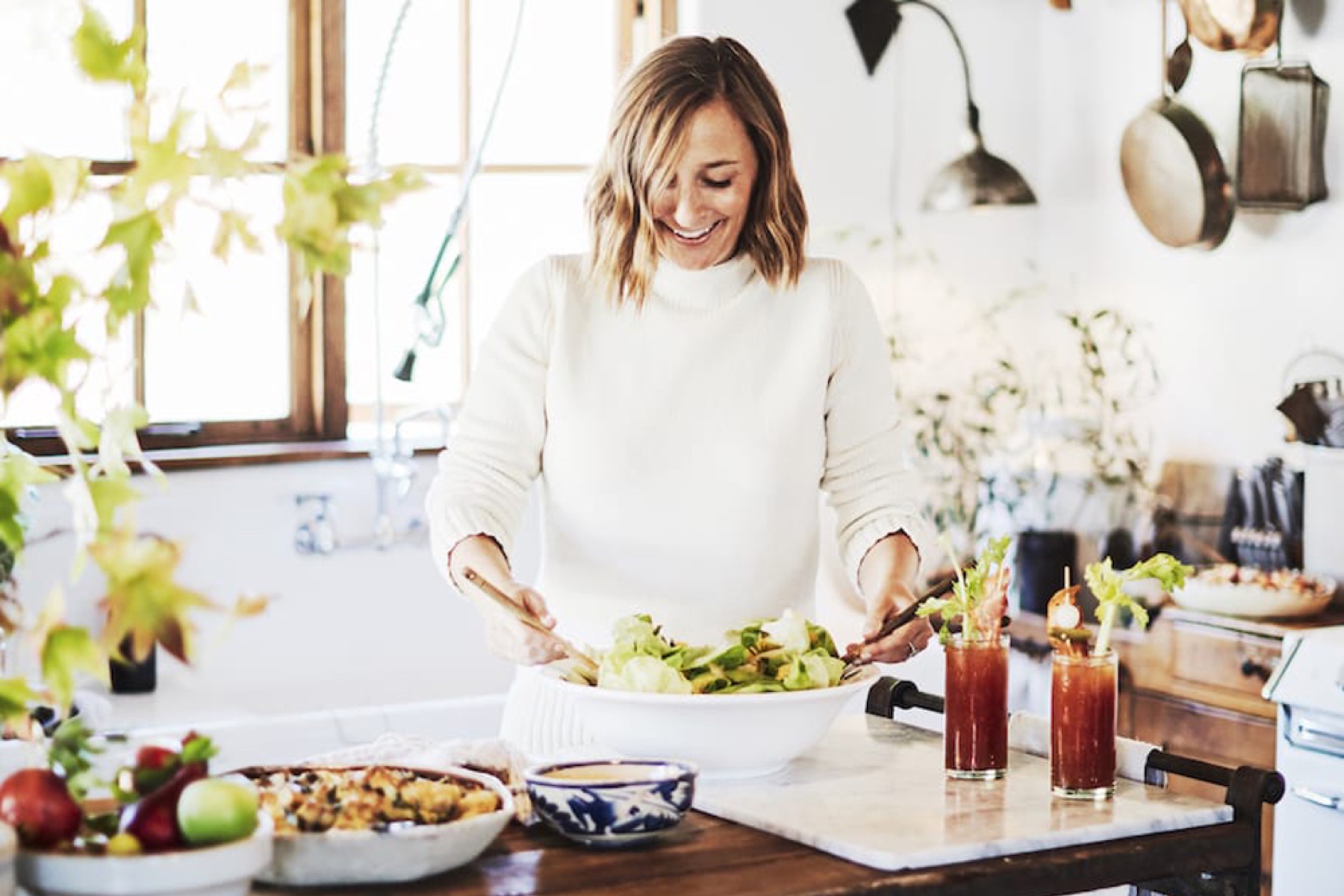 Gaby Dalkin in her kitchen preparing Friendsgiving cocktails