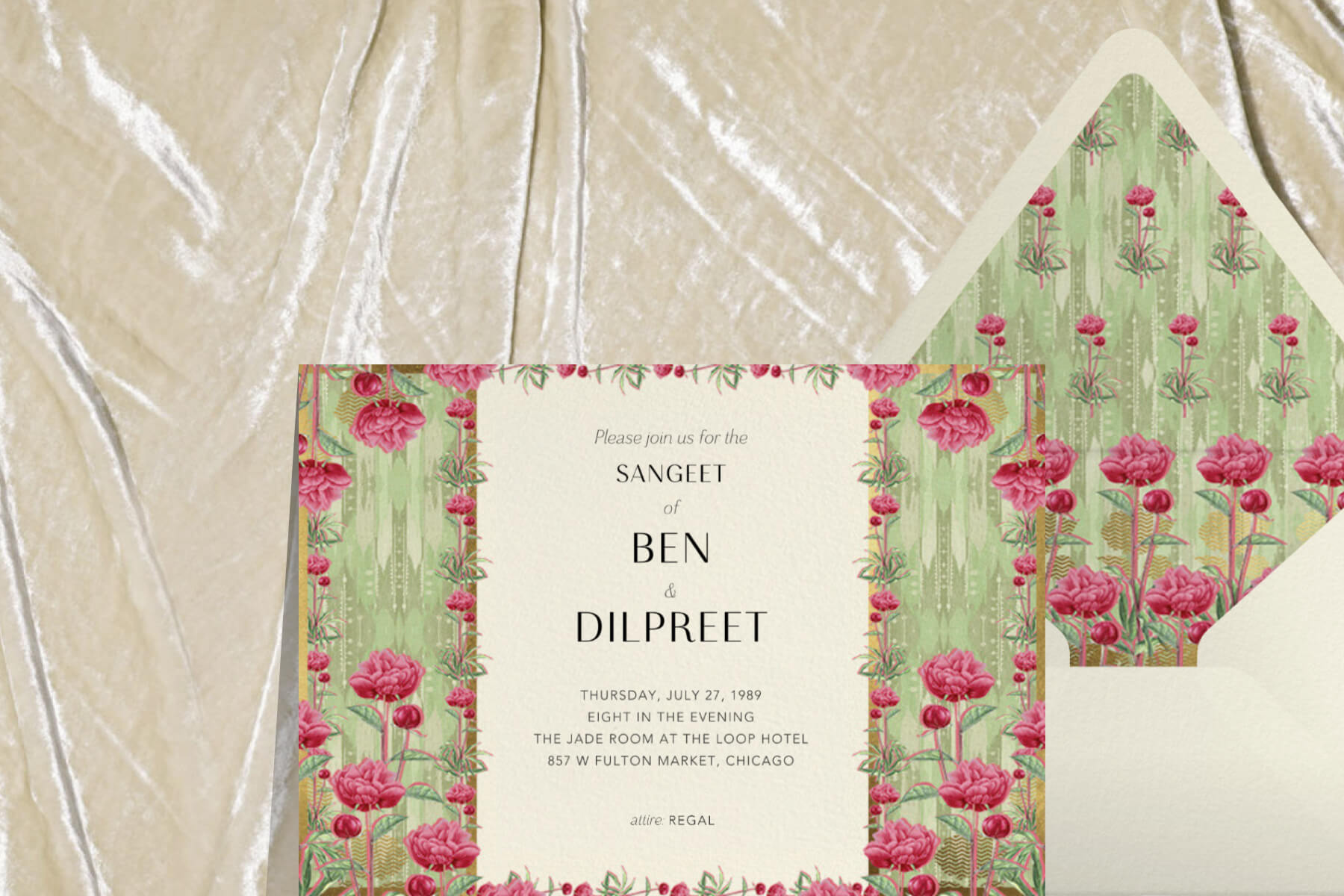 A horizontal Indian wedding invitation with a sage green and pink floral motif, paired with a cream envelope with a matching liner.