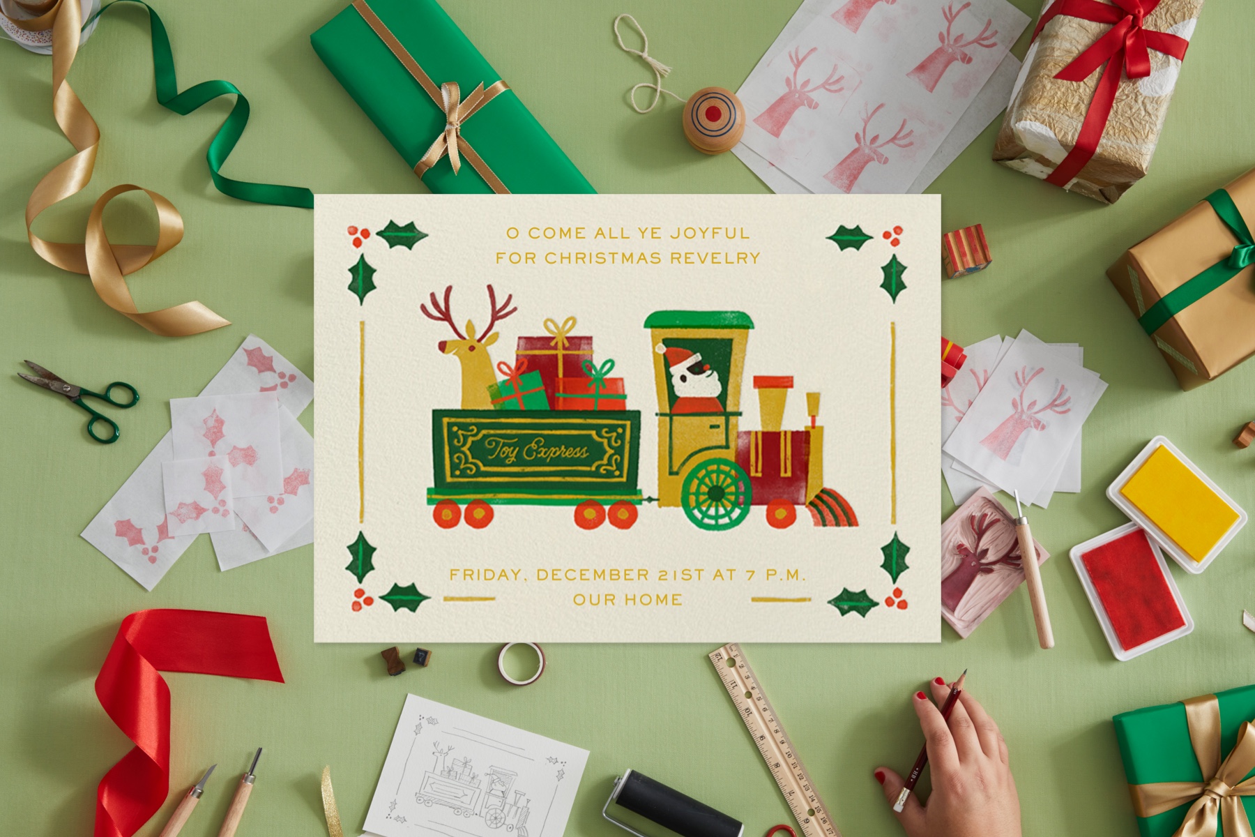 An invitation featuring Santa in a train pulling presents and a reindeer. The card is surrounded by items that inspired the artist, like ribbon, rubber stamps, and presents.