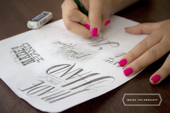 close up of person practicing different types of hand lettering in pencil
